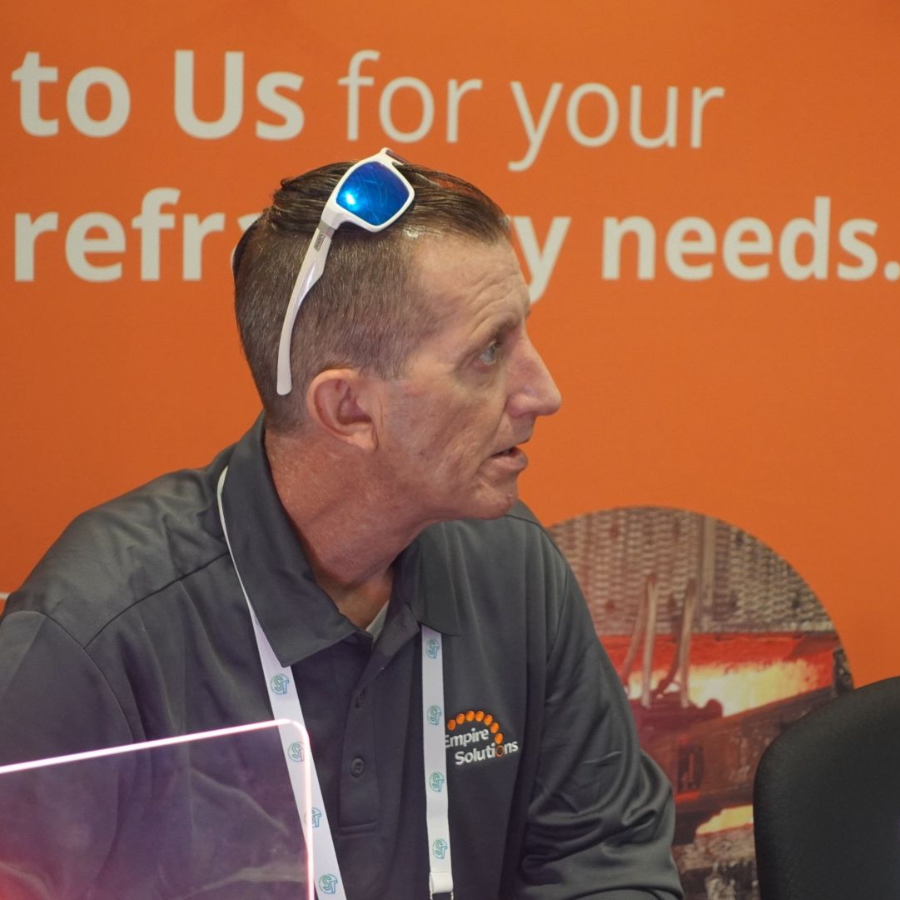 A member of Empire Solutions' team talks with an attendee at an event